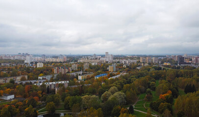 Top view of the autumn city near the park with trees