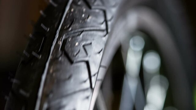 Bicycle Wheel Rotates. Rubber bicycle tire rotates in front of the lens. Filmed at a speed of 120fps