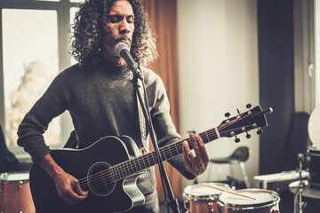 Obraz premium Handsome Guitarist in Years Perform Song at Studio .