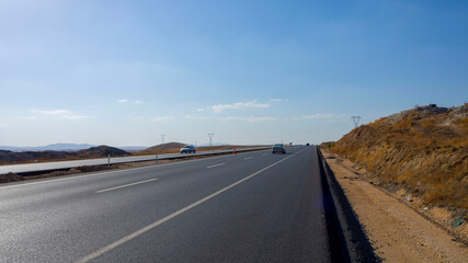 newly built asphalt road highway and vehicles long asphalt road,