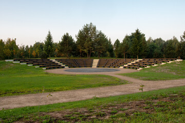 Empty seats at an outdoor amphitheater. Beautiful park scene and amphitheater for performances in the city park.