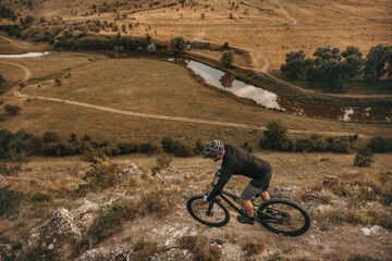 Fototapeta na wymiar Unrecognizable man riding bike in mountains