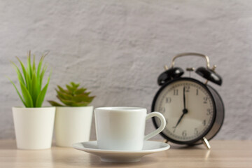 Small coffee Cup of morning coffee on the table.