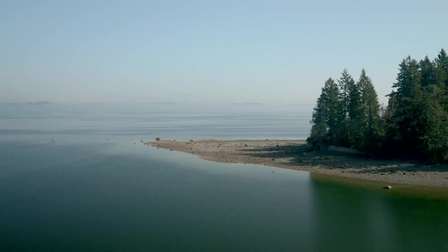 The Beautiful Aerial View In Penrose State Park Washington Surrounded With Quiet Seawater And Green Trees - Aerial Shot