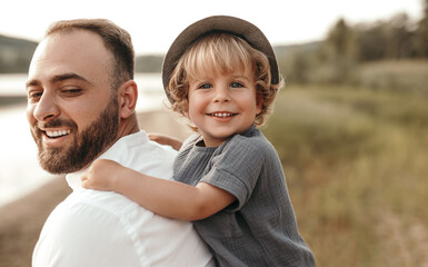 Obraz premium Happy father playing with son in countryside