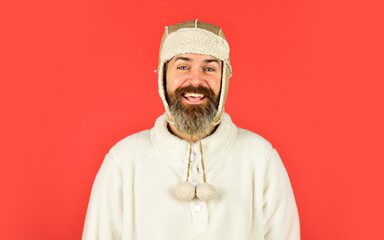 Handsome male model wearing warm hat. casual man in winter hat and warm clothes. happy hipster wear warm hat. cold and flu. Portrait of brutal man in fleece sweatshirt