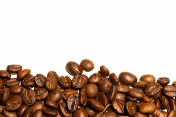 Roasted coffee beans background. Roasted seeds on white background. Copy space 