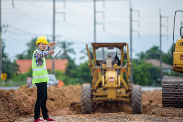 Asian engineers watch road rebuilding and inspect the construction of the road at the construction site.