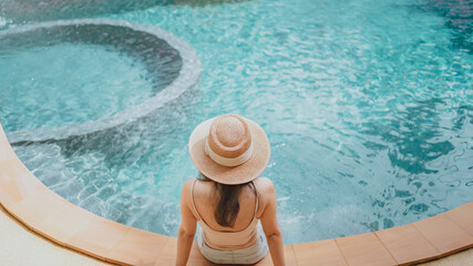 Happy woman enjoying on the pool in summer vacation, holiday concept.