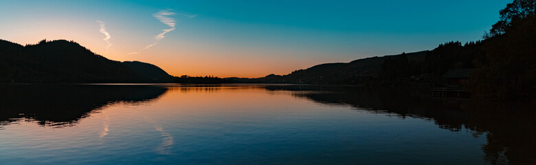High resolution stitched panorama of a beautiful alpine sunset view with reflections at the famous Schliersee, Bavaria, Germany