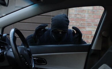 Thief looking in through a car window