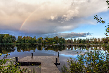 Naklejka na ściany i meble October rainbow over Swedish lake
