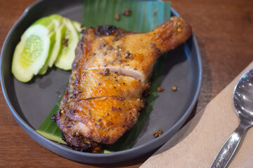 Grilled herb chicken style Thai ancient, chopped served with slice cucumber