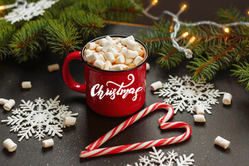 Banner Lettering Christmas. Christmas background. Happy New Year. Holiday Red mug with hot chocolate white marshmallows and candy in the shape of a Christmas tree. Selective focus.