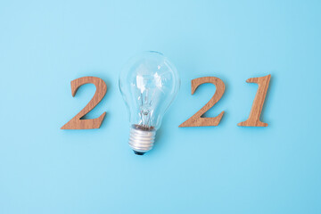 2021 Happy New year with lightbulb with and wooden number. New Start, Idea, Creative, Innovation, Resolution, Solution, Strategy, Goals and Mission concept