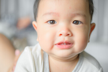11 months baby boy portrait, asian kid face, little boy smiling