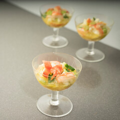 Traditional Peruvian gourmet ceviche crawfish filet piece with coriander in lime juice closeup in glasses