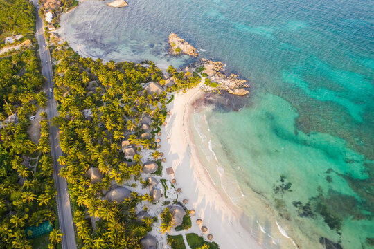 Aerial view of bungalow resorts on the Tulum coast in Mexico.