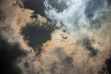 Obraz premium Dark and Dramatic Storm Clouds with sunlight in the background