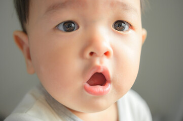 11 months baby boy portrait, asian kid face, little boy smiling