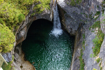 Beautiful backdrop of a waterfall in a canyon with clear water close to the Neuschwanstein Castle in Germany