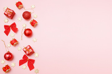 Christmas greating card composition. Christmas red and golden decorations with on pink background. Flat lay, top view, copy space