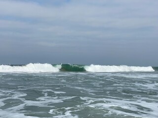 Ocean Wave Cresting, Frothy Water Foreground 