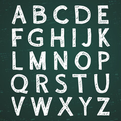 Hand-drawn alphabet. Calligraphy font. Modern chalk lettering. Letters on the green board