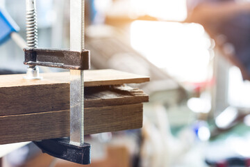 Woodworking clamps are used to hold the wood together using glue as a binder.
