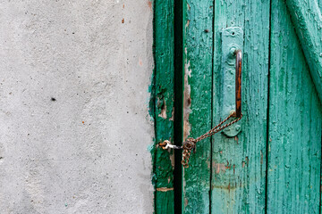 Old vintage door handles. Rusty metal locks and latches. Protective devices for wooden yard gates