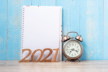 2021 Happy New Year  with blank notebook, retro alarm clock and wooden number. New Start, Resolution, Goals, Plan, Action and Mission Concept
