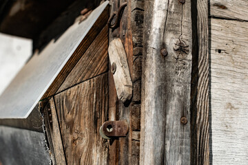 Old vintage door handles. Rusty metal locks and latches. Protective devices for wooden yard gates