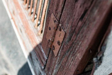 Old vintage door handles. Rusty metal locks and latches. Protective devices for wooden yard gates