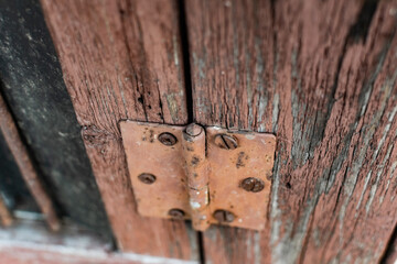 Old vintage door handles. Rusty metal locks and latches. Protective devices for wooden yard gates
