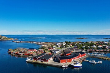 Fototapeta na wymiar Drone view of red fishing cabins, islands and ocean in Lofoten, Norway