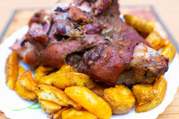 Top view tasty pork shank and mashed potato on the plate closeup. Vertical