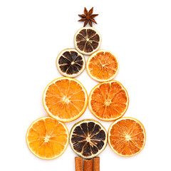 Christmas tree made of dried oranges and lime slices, cinnamon sticks and star anise. Square composition.