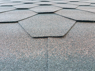 Bottom view of a roof with shingles folded in a hexagon shape.
