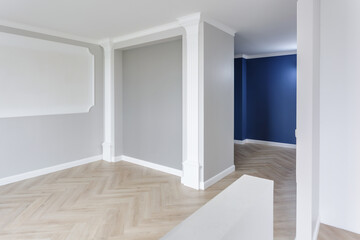 Empty room with minimal preparatory repairs with crown molding. interior of white and gray walls