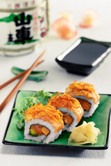 Sushi rolls set served on green plate on light background.Menu concept.