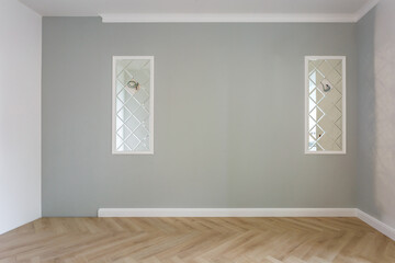 Empty room with minimal preparatory repairs with crown molding. interior of white and gray walls