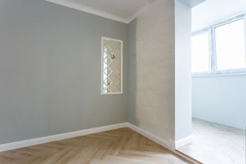Empty room with minimal preparatory repairs with crown molding. interior of white and gray walls