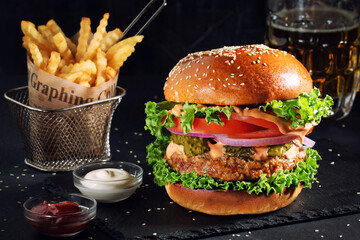 fresh tasty burger and french fries on  table