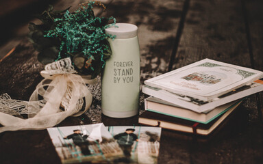 books, thermos and dry bouquet