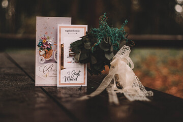 postcards and dried flowers on a wooden table