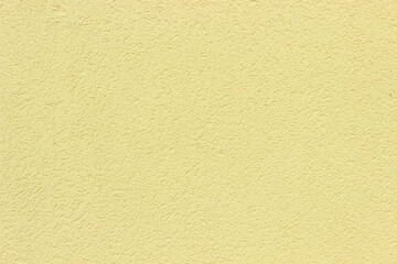 Light yellow pastel coloured plaster work wall background texture perfect for interior design
