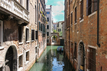 Fototapeta na wymiar Beautiful quiet small canal ,with a boat, in Venice . Beautiful and romantic travel destination concept.