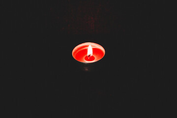 candle burning against dark background