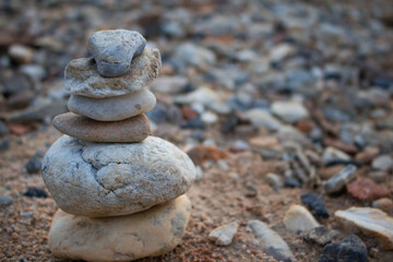Fototapeta na wymiar Zen Stones / Zen stone on beach for perfect meditation. Calm zen meditate background with rock pyramid on sand