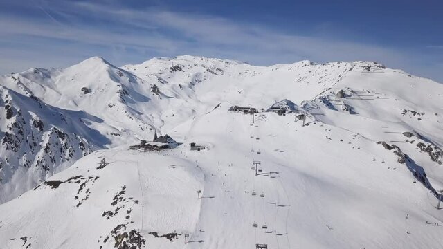 Aerial view of skiers on ski slopes in Horberg area, Mayrhofen ski, Tyrol, Austria. Speeded up from 24 fps.
